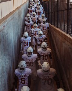 a football team is lined up in the tunnel