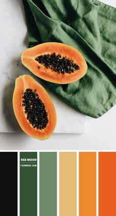 two pieces of papaya sitting on top of a white counter next to a green napkin