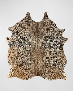 an animal print area rug is shown in the shape of a cow's skin