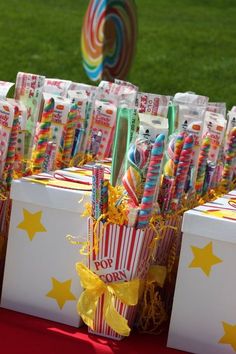 many candy bars are lined up in boxes on a red tablecloth with yellow stars