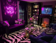 a living room with zebra print rugs and purple lighting on the walls, two couches in front of a television