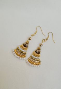 Discover elegance with my exquisite handmade beaded earrings, perfect for adding a touch of sophistication to any outfit. Each pair is unique and reflects both artistry and style. Whether you're dressing up for a special occasion or looking to elevate your everyday ensemble, my beaded earrings are versatile and chic. They make a wonderful gift for someone special or a delightful treat for yourself. Elegant Beaded Earrings With Dangling Beads For Festive Occasions, Gold Beaded Earrings For Celebration, Elegant Tiny Beads Dangle Earrings, Elegant Adjustable Beaded Earrings With Colorful Beads, Elegant Tiny Beaded Drop Earrings, Elegant Dangle Chandelier Earrings With Tiny Beads, Adjustable Round Beaded Earrings For Festive Occasions, Elegant Adjustable Colorful Beaded Earrings, Elegant Gold Earrings With Tiny Beads