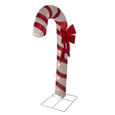 a candy cane with red and white stripes on it's side is lit up