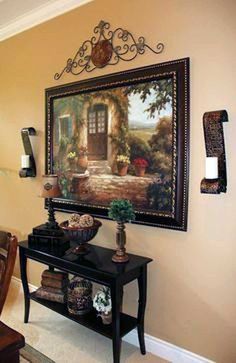 a painting hanging on the wall above a table