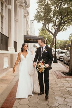 a newly married couple walking down the street