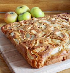 an apple pie sitting on top of a wooden cutting board