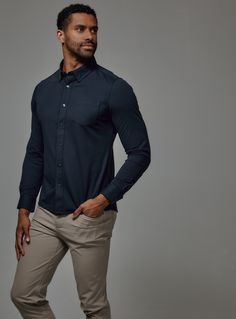 We created the perfect long sleeve button up, with the right mixture of comfort and style, just for you. This shirt features a unique comfort stretch fabric that's both soft and airy. Includes loop button down collar and patch pocket detail. Details Model is 6'1" and wears a size medium. Care: Machine wash cold, wash dark and light colors separately, tumble dry low, warm iron or dry clean for best results. Composition: 55% Cotton | 45% Polyester Casual Navy Button-up Dress Shirt, Navy Relaxed Fit Long Sleeve T-shirt, Indigo Relaxed Fit Button-up Shirt, Indigo Cotton Button-up Shirt, Relaxed Fit Henley T-shirt With Button Closure, Dark And Light, Button Down Collar, Pocket Detail, Modern Fit