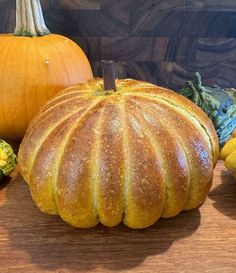 pumpkins and gourds on a wooden table