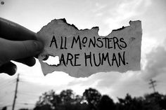 someone holding up a piece of paper with the words all monsters are human written on it