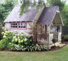 a small house with flowers in the front yard