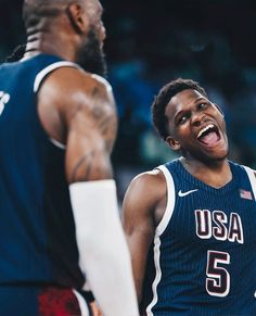 a man with his mouth open standing next to another man wearing a jersey that says usa