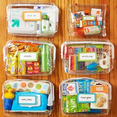 four clear containers filled with school supplies on top of a wooden table next to a rubber duck