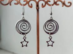 The earrings are decorated with pendants in the shape of a round spiral and a small star. The earrings are fastened with stainless steel studs. Earring length - 4.0 cm (1.6 inches) Earrings are packed in a gift box RECOMMENDATIONS FOR CARE: Do not wet, do not drop, and store in a dark box! - Remove jewelry before exercising, swimming, showering and sleeping. - Avoid contact with moisture such as make-up, moisturizer, lotion, perfume and hairspray. - Store your jewelry in a box or pouch after use. Whimsigoth Earrings, Spiral Star, Y2k Grunge Style, Nose Ring Jewelry, Downward Spiral, Spiral Galaxy, Swirl Earrings, Dope Jewelry, Spiral Earrings