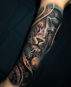 a man's arm with a lion and helmet on it