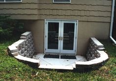 an outside view of a house with stone walls and doors