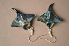 Manta Ray Necklace and Earrings. You may purchase them together or separately. The Earrings and pendant are a black color over laid with a coloring. The coloring on each one comes out a little bit different. SIZE: These earrings are each about one inch long. Most of the time when they are smaller the become harder to make. Manipulating the glass to get the right shape can be a challenge. The pendant is about an inch and a half in length. EAR WIRES: The come with a Silver colored hypoallergenic e Manta Ray Earrings, Unique Black Beach Jewelry, Black Dangle Jewelry For Beach, Ocean Accessories, Hummingbird Earrings, 3d Studio, Ocean Jewelry, Manta Ray, Dope Jewelry