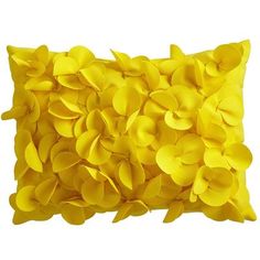 a yellow pillow that has been made out of flowers on the front and back of it