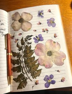 an open notebook with flowers and leaves on it