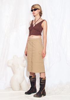 Y2K vintage cargo skirt. Made from cotton, this minimalist skirt comes in beige with four pockets to stash all your goodies. With a zip closure and 2000s vibes, it's the buttery-soft swag you need. Our model, Szonja is 173 cm / 67.5" tall and she's a size XS. Size: XS / US 2 / UK 6 / IT 38 Other size info: Labelled size: 34 Measurements:  waist: 72 cm / 28.1" length: 62 cm / 24.2" Fabric: cotton 97%, elastane 3% Care: Machine wash inside out Beige Cotton Cargo Skirt With Pockets, Beige Cargo Skirt With Utility Style, Beige Utility Cargo Skirt, Khaki Cotton Cargo Skirt, Fitted Khaki Cargo Skirt In Utility Style, Fitted Khaki Cargo Skirt With Utility Style, Fitted Khaki Utility Cargo Skirt, Cargo Skirt, Style Expert