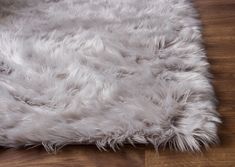 an area rug with white fur on the floor