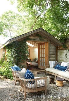 an outdoor living area with couches and chairs