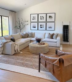 a living room filled with furniture and pictures on the wall