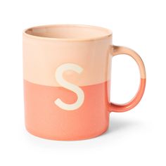 an orange and pink mug with the letter s on it