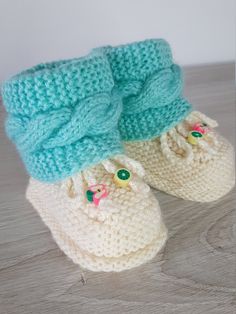 Adorable Baby Booties (0-6 Months) Wrap your little one's feet in warmth and comfort with our charming baby booties. Perfectly sized for newborns to 6 months, these booties are crafted with soft, high-quality yarn to ensure gentle care for delicate baby feet. The cute design and delicate details make them a wonderful gift for new parents or a lovely addition to your own baby's wardrobe. Easy to slip on and off, these booties stay snug and secure, providing both style and practicality. Features: Cozy Knitted Booties With Round Toe, Comfortable Soft Booties For Playtime, Casual Hand Knitted Round Toe Booties, Winter Playtime Booties With Soft Sole, Cozy Soft Booties With Round Toe, Comfortable Cream Winter Booties, Comfortable White Winter Booties, Cozy Cream Winter Booties, Handmade Comfortable Winter Booties