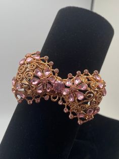 A beautiful Betsy Johnson cuff bracelet, rose gold tone, giant bow with plenty of clear and pink stones! NOTE:  larger pink tear drop stone has come loose, but is included. Pink Metal Bracelets For Wedding, Elegant Adjustable Jewelry With Pink Bow, Feminine Party Jewelry With Pink Bow, Elegant Pink Metal Crystal Bracelet, Elegant Gold Jewelry With Pink Bow, Wedding Jewelry With Pink Bow, Pink Metal Bracelets For Party, Rose Gold Crystal Bracelet With Sparkling Stones For Party, Party Rose Gold Crystal Bracelet With Sparkling Stones