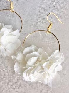 Elegant White Flower Hoop Earrings, Delicate White Hoop Earrings For Wedding, White Dainty Bridal Earrings For Parties, Bohemian White Jewelry With Flower Decoration, White Bohemian Jewelry With Flower Decoration, Elegant Adjustable White Hoop Earrings, Adjustable White Hoop Earrings For Wedding, Bohemian Wedding Hoop Earrings With Ear Wire, Delicate Handmade White Hoop Earrings