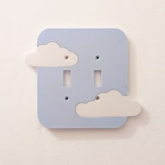 a light switch cover with two clouds on it