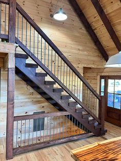 a wooden staircase with metal handrails in a home