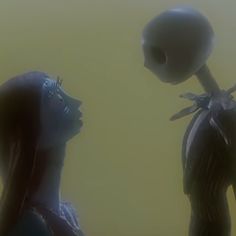 an alien standing next to a woman