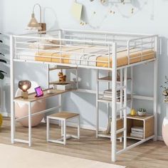 a loft bed with desk underneath it in a room that has white walls and wooden floors