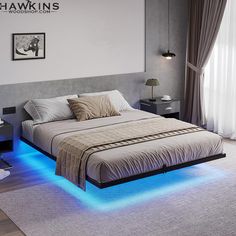 a bedroom with a bed that has blue lights on the bottom and sides, along with a white rug