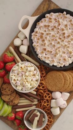 an assortment of snacks including marshmallows, pretzels and cookies