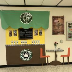 the interior of a starbucks coffee shop with two tables and three chairs in front of it