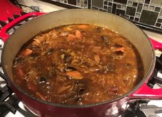 a pot filled with stew sitting on top of a stove