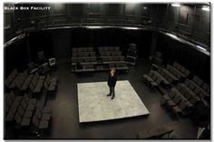 a man standing on top of a white rug in a theater