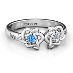 two heart shaped rings with the names forever and blue topaze on each ring