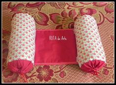 two rolls of fabric sitting on top of a bed next to each other with the words rolla al art written on them