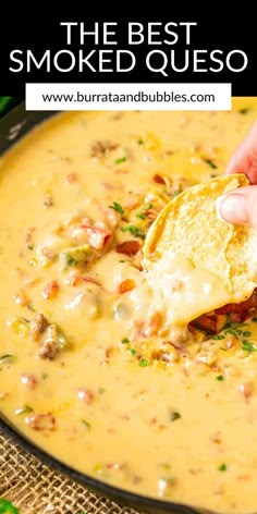 a hand dipping a tortilla chip into a bowl of quesadilla soup