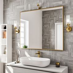 a bathroom with a sink, mirror and shelving unit in the corner that has gold accents