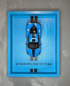 a blue sports car is in a display case with the word corvette on it's side