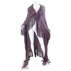 Gorgeous and rare late 1990s MISSONI colorful knit fringe cape wrap shawl ) ! This beauty measures an impressive 60 inches x 60 inches ( 5 feet x 5 feet ). Bright vibrant colors of purple, turquoise blue, orange, and green throughout. Crochet like details. Soft rayon blended knit fabric. Entire edges have fringe. Would even be fabulous as a throw on a sofa. Pair with jeans or a dress. Can fit any size In great unworn condition Made in Italy Measurements: 60 inches by 60 inches Multicolor Tassel Shawl For Fall, Multicolor Shawl With Tassels For Festival, Multicolor Cape Shawl For Festival, Multicolor Tassel Shawl For Festival, One Size Fringe Cape Shawl, Fall Multicolor Fringe Shawl, One Size Fringe Shawl Cape, Multicolor Shawl Cape One Size, Multicolor Fringe Shawl For Winter