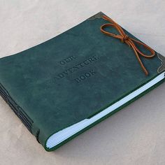 an old green book with the words our adventure book written on it's cover