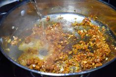 the food is being cooked in the pot on the stove