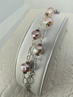 "This is an original design of natural pink Freshwater pearls and sterling silver- 2 strands designed to mix well in an alternating fashion. It can be worn 7 1/2\" or 8\" depending on where you hook the clasp.  You can also twist the pearls and make it tighter for an alternate look. I can only make this a few times- it is very hard to find these bigger natural pink pearls.   I wanted a breezy, high fashion look.  Perfect for Spring,  Bridal party  and other Special Occasions. Because this is rar Pink Pearl Drop Bracelet For Wedding, Pink Pearl Bracelet With Pearl Drop, Elegant Pink Bracelets With Pearl Chain, Silver Single Strand Pearl Bracelet Gift, Silver Single Strand Pearl Bracelet As Gift, Pink Elegant Single Strand Beaded Bracelets, Elegant Pink Single Strand Beaded Bracelets, Silver Single Strand Pearl Bracelets, Elegant Pink Sterling Silver Round Bracelet