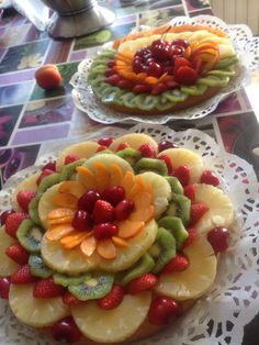 two plates with fruit on them sitting on a table