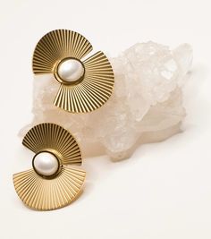 Stand out with the Sophia pearl fan earrings by Musenwolfe, these 18k gold plated stainless steel earrings are party perfect.  These stainless steel beauties are tarnish free and waterproof.  All of our jewelry comes in a beautiful 100% cotton pouch. It makes the perfect gift! Materials: 18k gold plated stainless steel Dimensions: 1.25" x 1.25" Modern Gold Metal Pearl Earrings, Gold Plated Metal Pearl Earrings, Metal Pearl Earrings With Plating For Gifts, Metal Plated Pearl Earrings For Gifts, Gift Pearl Earrings With Metal Plating, Gold Pearl Earrings Tarnish Resistant, Modern Pearl Earrings, Pearl Statement Earrings, Fan Earrings